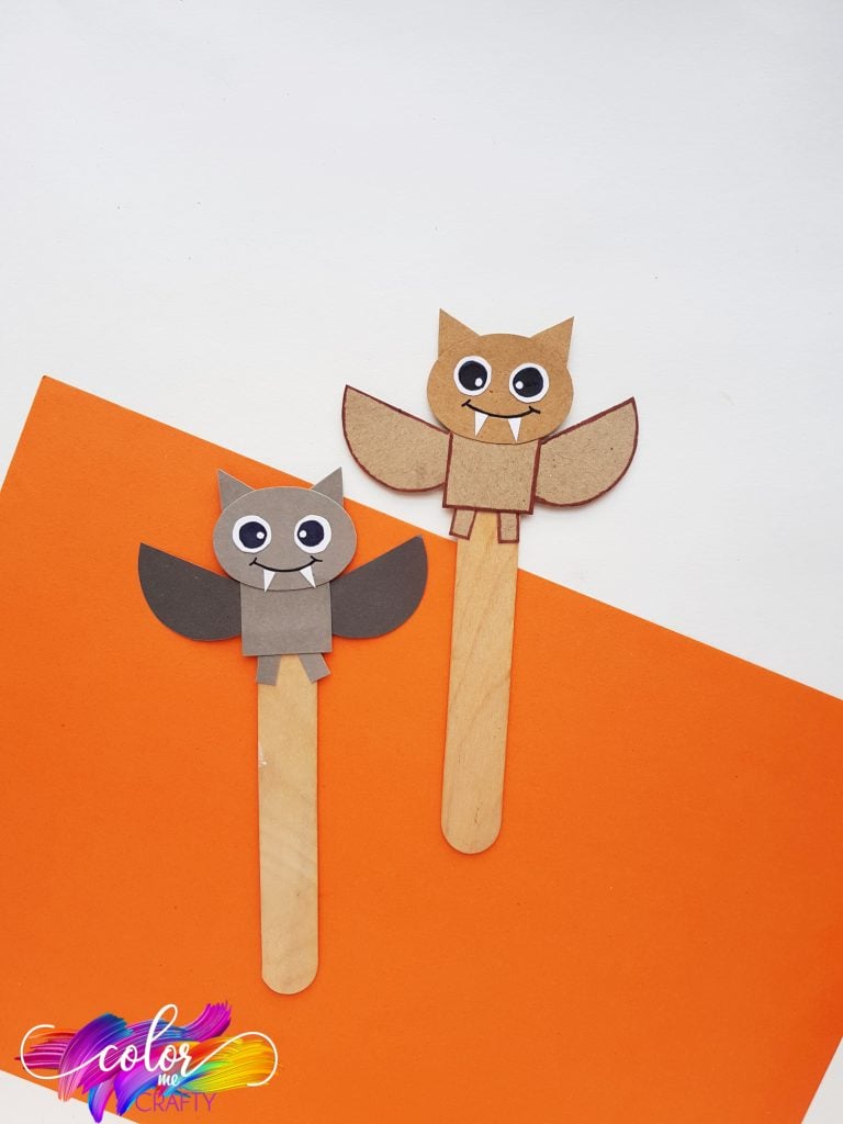 gray and brown paper bat bookmarks on popsicle sticks with cute faces