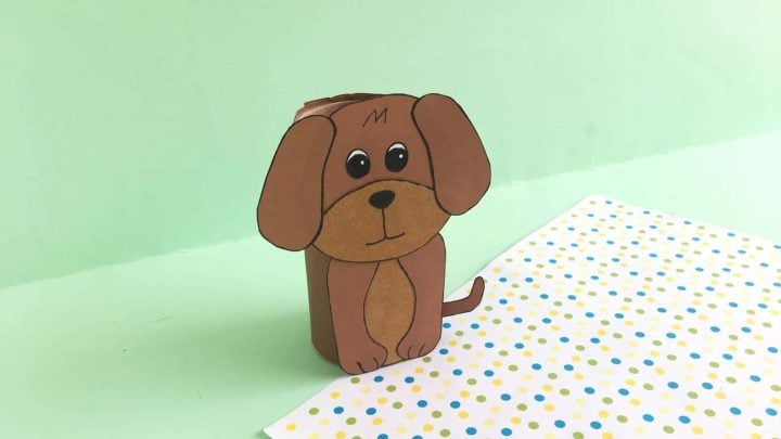 cute brown dog made with toilet paper roll with green background