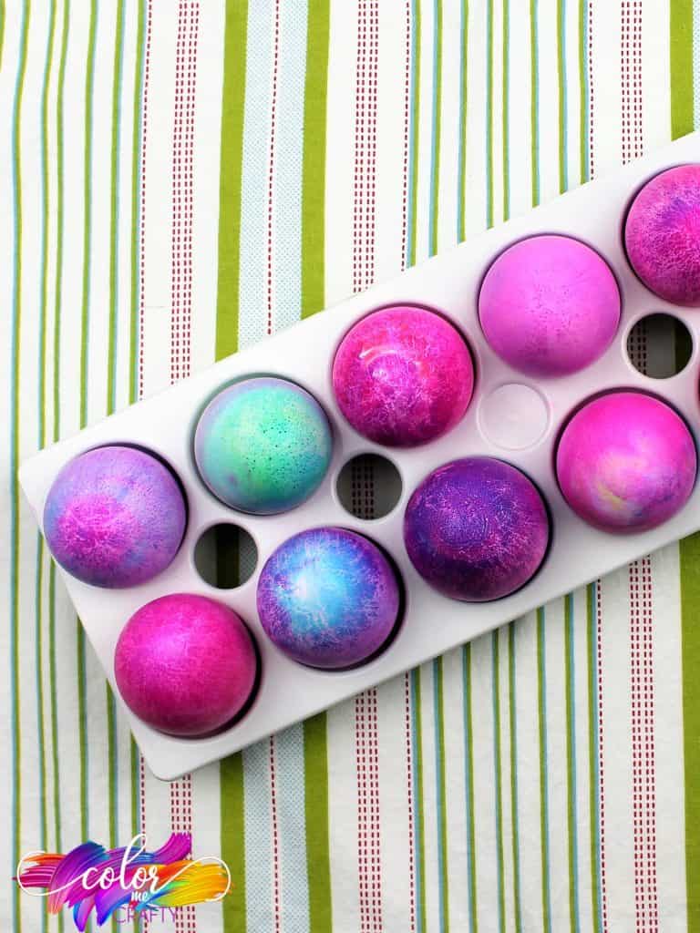 cut off top view of blue and purple dyed easter eggs