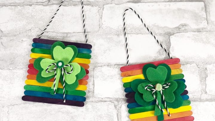 two colorful shamrock wall hangings with supplies from dollar tree