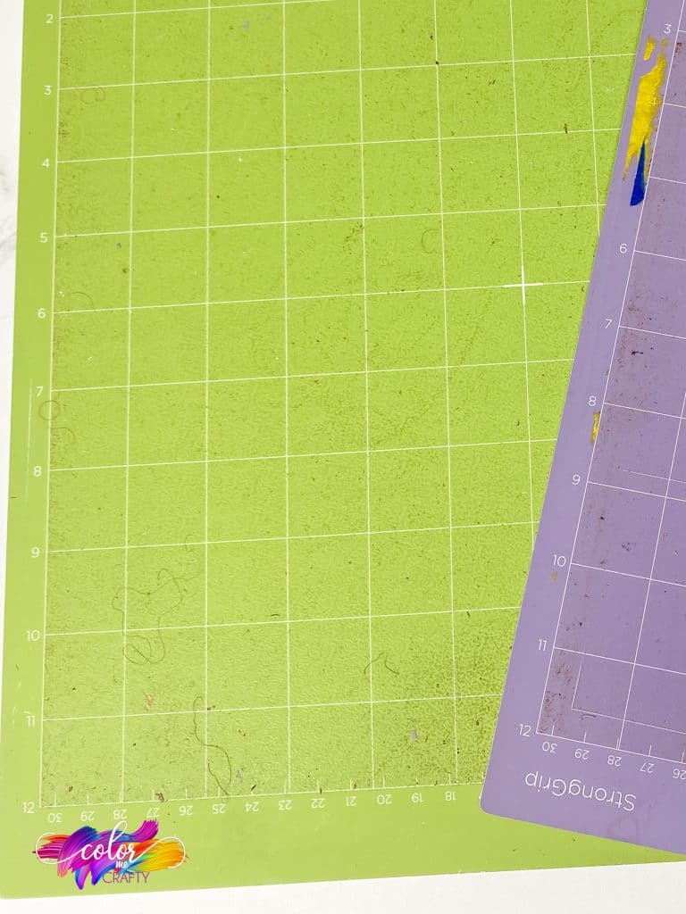close up of standard grip cutting mat with dirt and debris on it