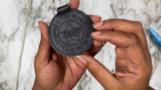 cricut leather keychain being held by hands