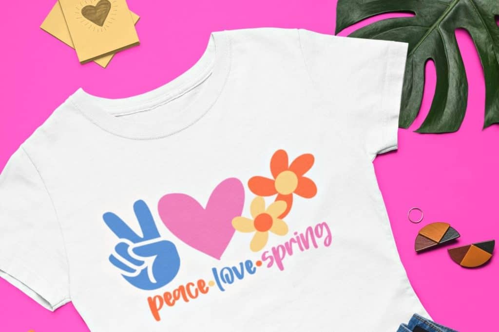 shirt mockup made with a peace love in the colors blue, pink, yellow and orange