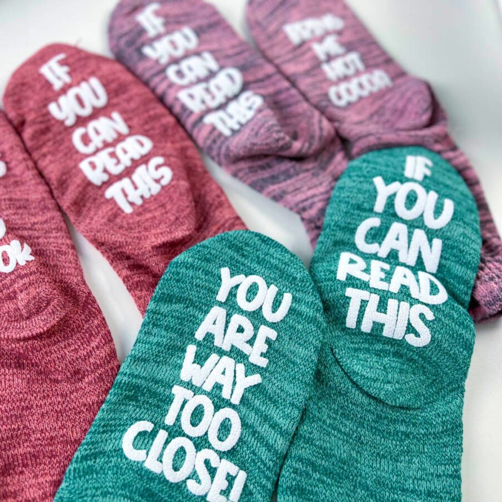 Different designs on green, red, and purple socks.