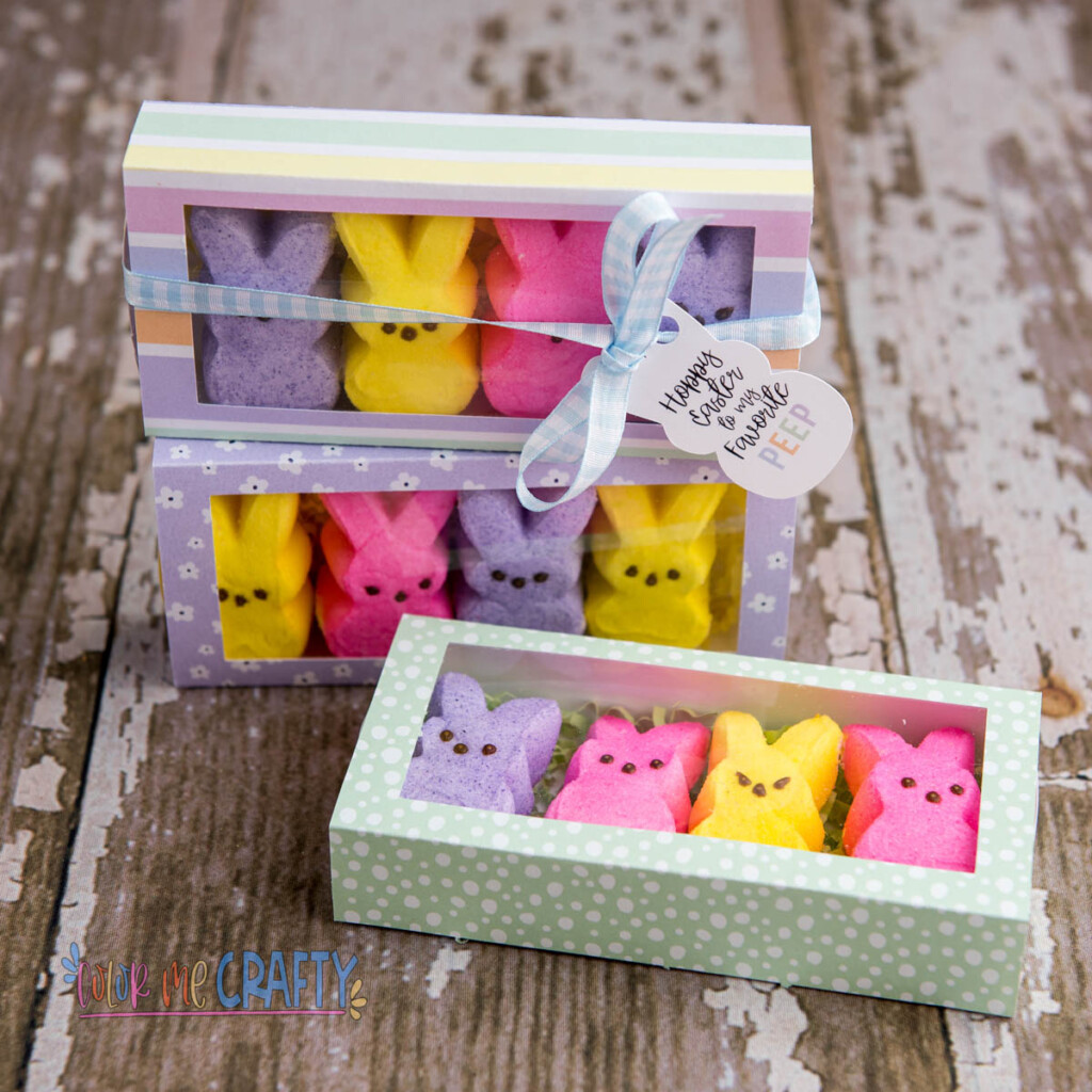 DIY treat boxes made with Cricut machine, colorful paper patterns, tags, and blue ribbon.
