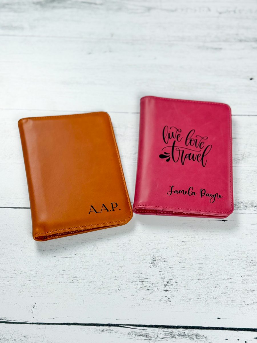 Laser engraved faux leather passport covers, one tan with initials and one pink with live love travel
