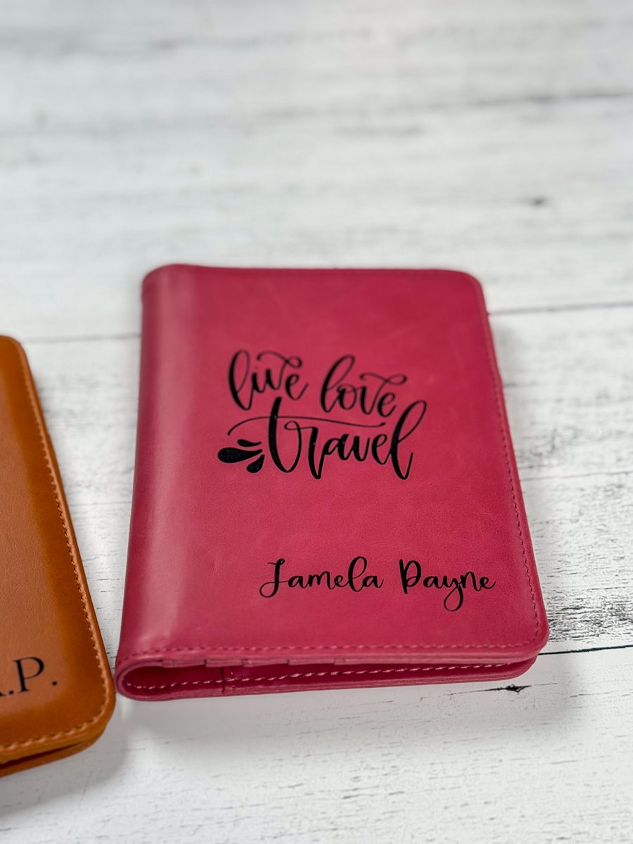 Pink faux leather passport cover laser engraved with live love travel and a name