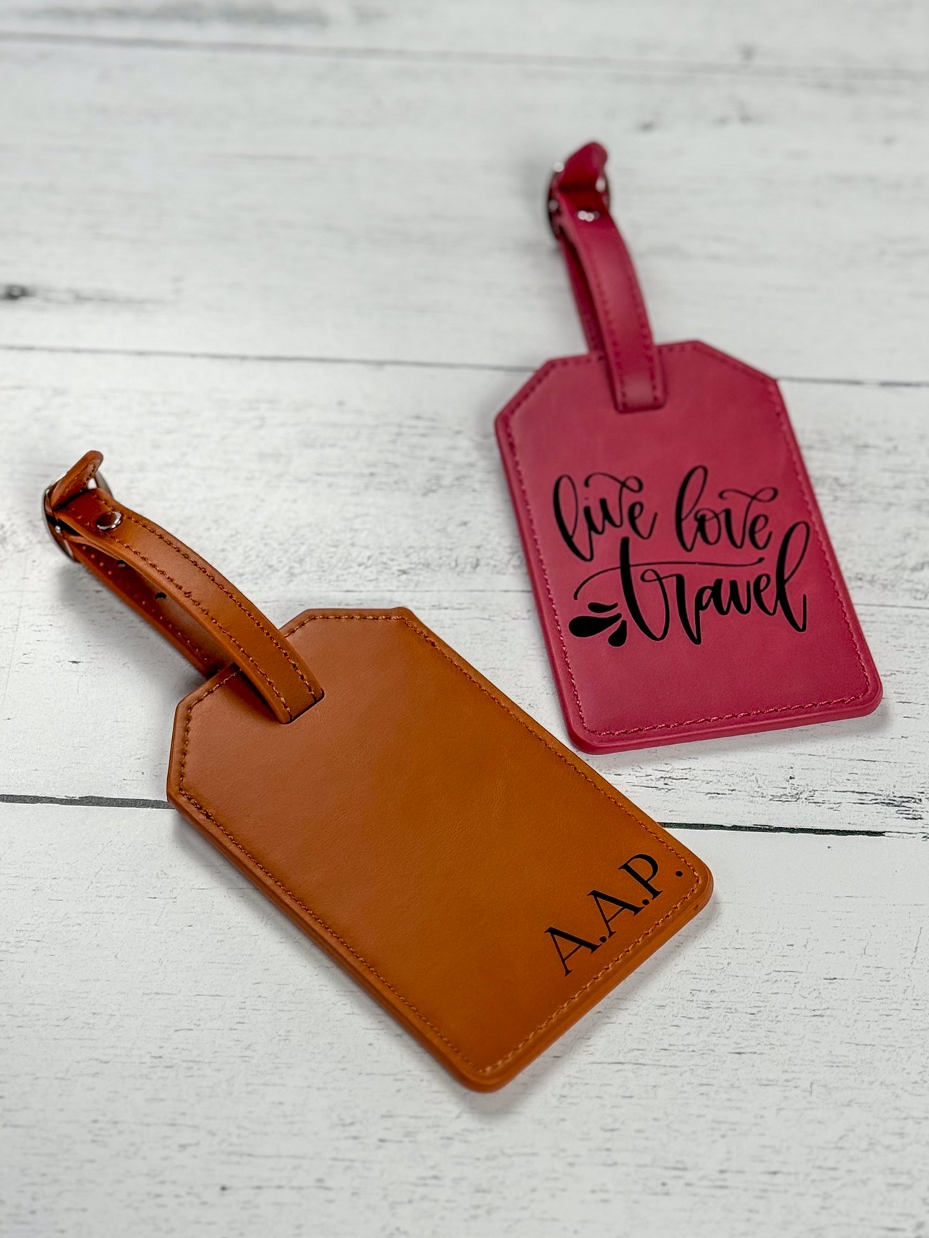 Rawhide and pink Laserette luggage tags engraved with settings from a laser material test