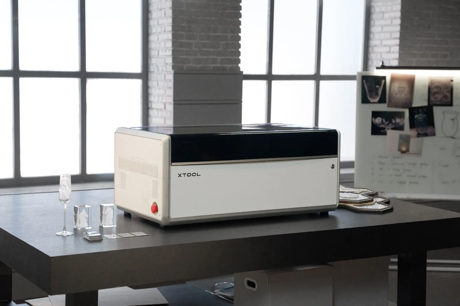 xTool X1 laser in a studio with engraved crystal and glass